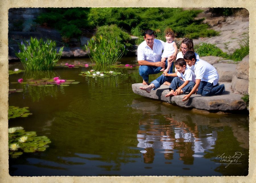 family portrait beside a pond