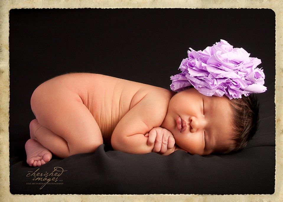 newborn baby with purple flower