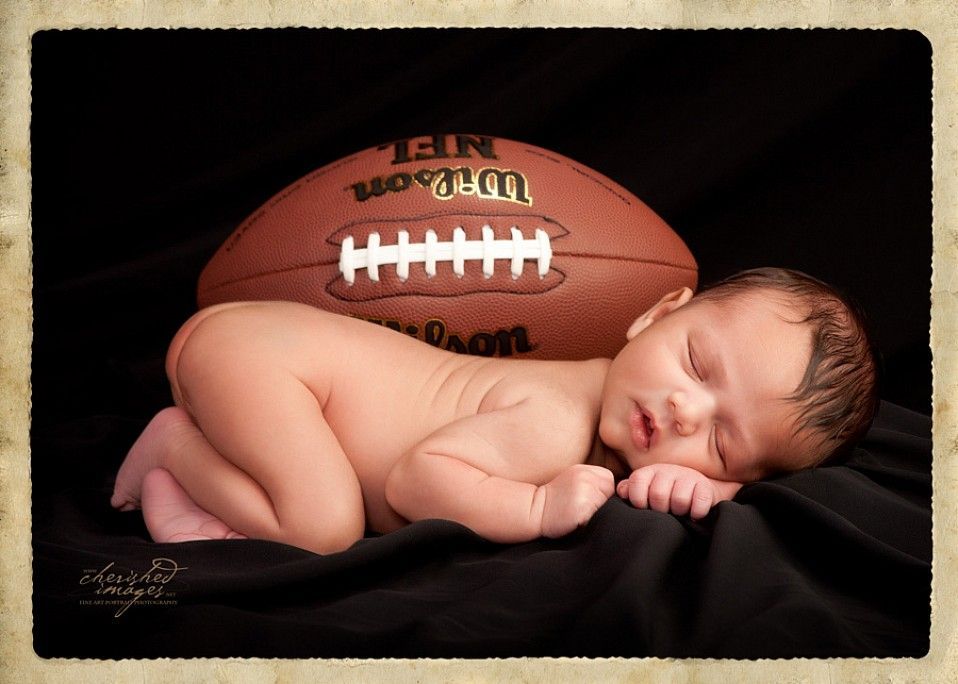 newborn baby with football
