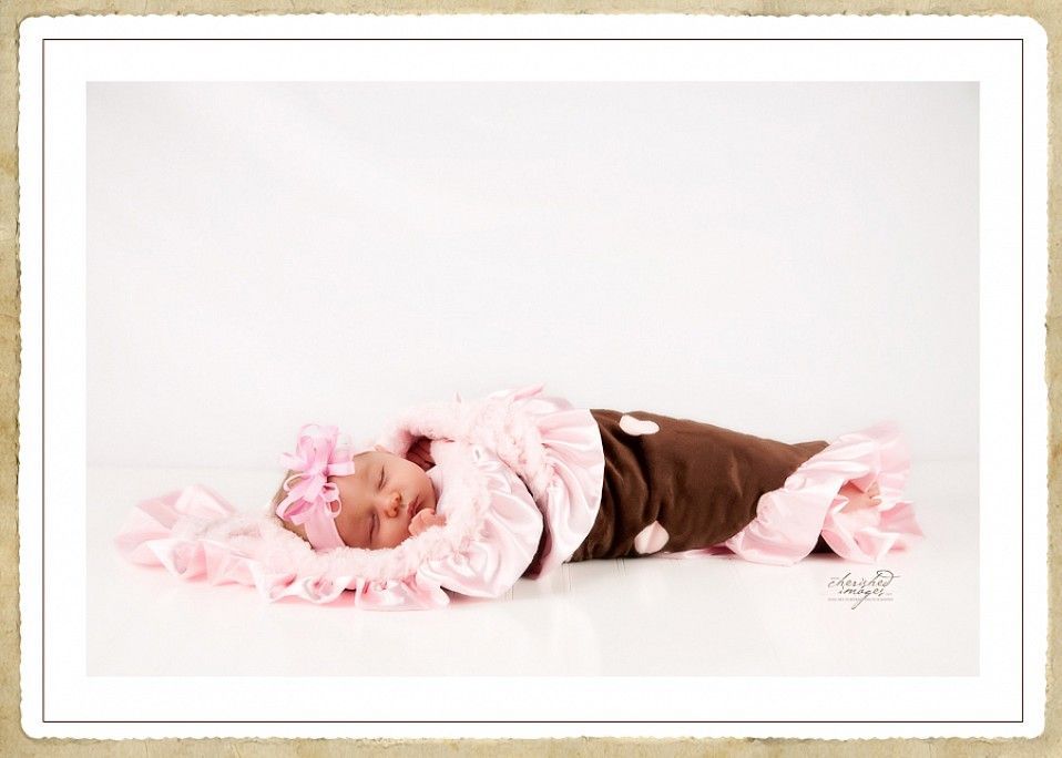 newborn baby in pink and brown