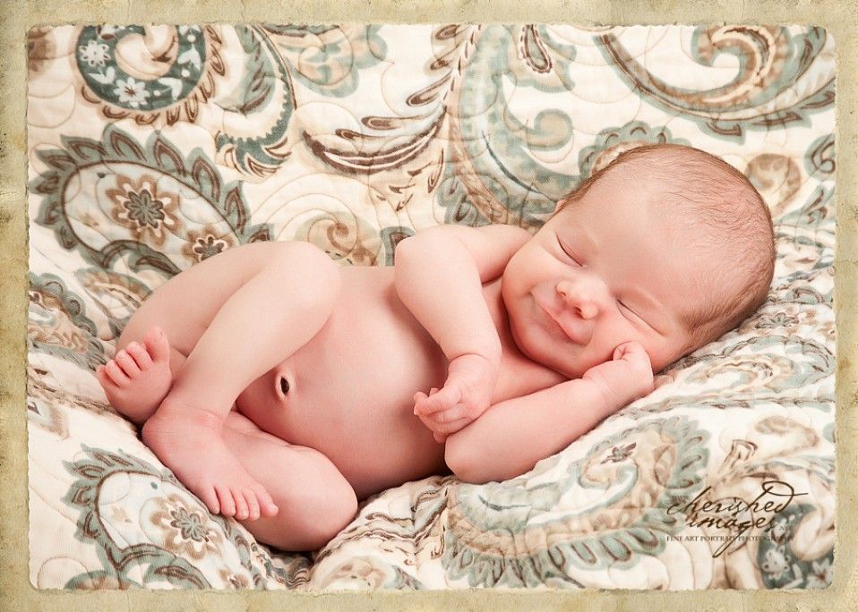 newborn baby smiling