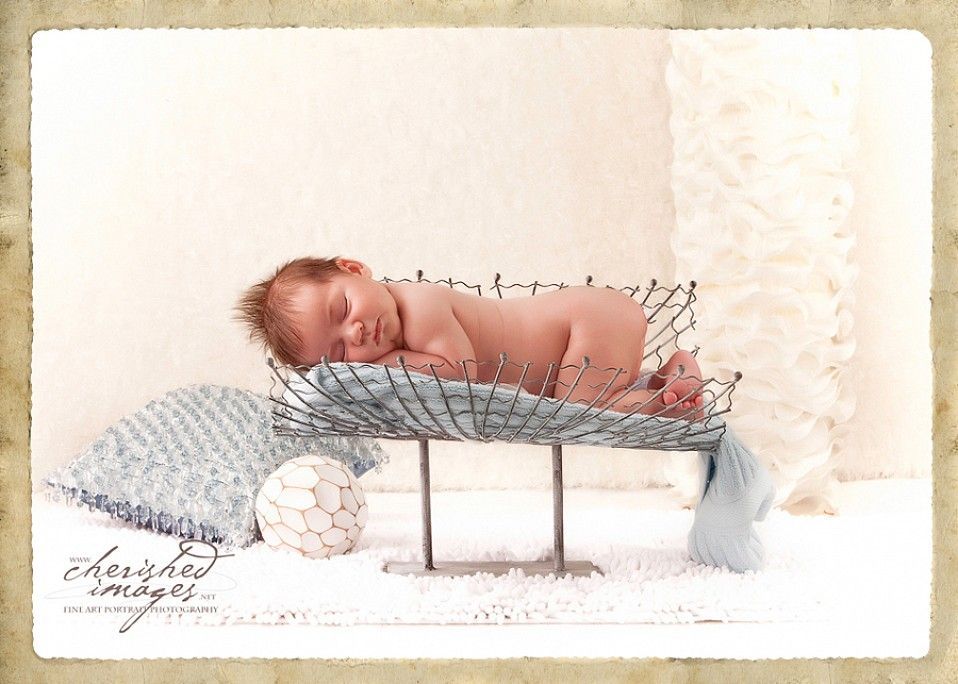 newborn baby in blue and white